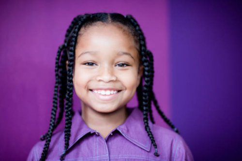 smiling girl (8-9) with plaits, portrait, close-up - hairstyle photos et images de collection