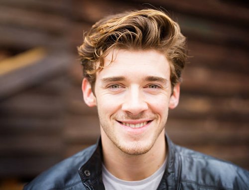 smiling handsome happy cheerful english male student wearing leather jacket - hairstyle stock pictures, royalty-free photos & images