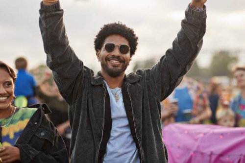 smiling man dancing with arms raised by woman - concert stock pictures, royalty-free photos & images