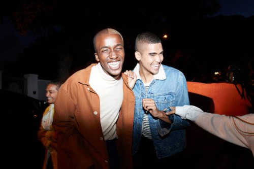 smiling men enjoying with friends at night - fashion stock pictures, royalty-free photos & images