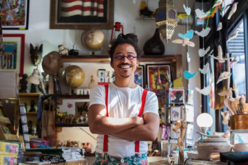 smiling mixed race man wearing suspenders - fashion stock pictures, royalty-free photos & images
