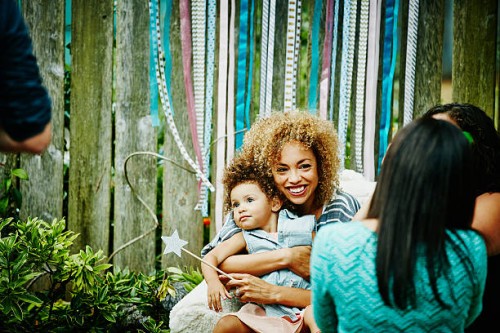 smiling mother embracing toddler daughter - garden decoration stock pictures, royalty-free photos & images