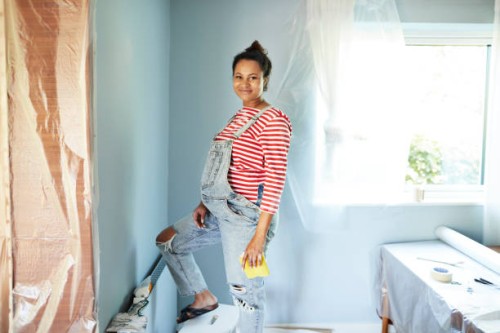 smiling pregnant woman renovating room - home decoration stock pictures, royalty-free photos & images