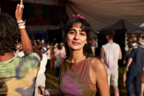 smiling woman dancing by friend at music concert - concert stock pictures, royalty-free photos & images