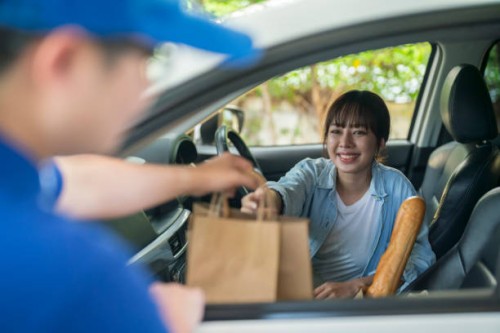 smiling woman taking orders on the side of the road - junk food stock pictures, royalty-free photos & images