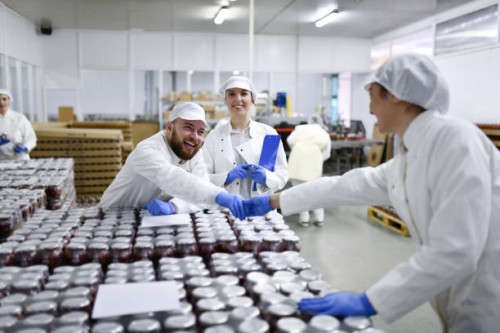 smiling workers in pepper processing plant shaking hands and getting ready to take jars to storage room - food stock pictures, royalty-free photos & images