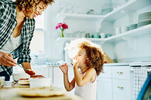 smiling young girl making pizza with mother - food stock pictures, royalty-free photos & images