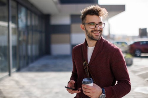 smiling young man commuting to work - junk food stock pictures, royalty-free photos & images
