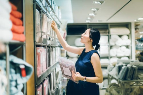 smiling young pregnant woman shopping for home necessities in shop - home decoration stock pictures, royalty-free photos & images