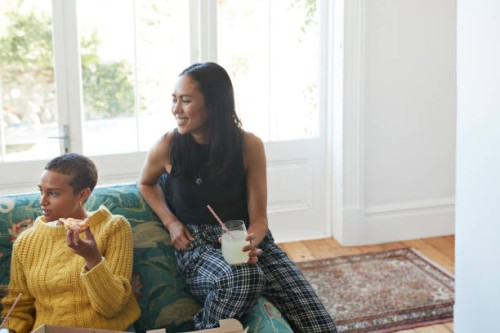 smiling young women with fresh pizza and drink - junk food stock pictures, royalty-free photos & images