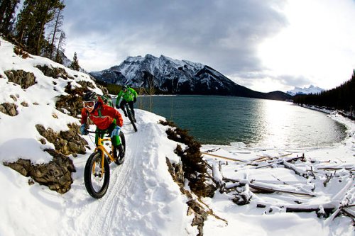 snow biking couple - travel stock pictures, royalty-free photos & images