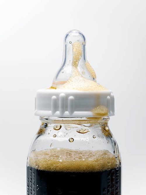soda in baby bottle - junk food stock-fotos und bilder
