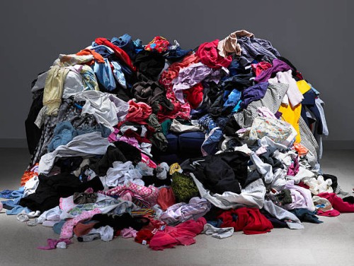 sofa buried under piles of clothes - fashion stock pictures, royalty-free photos & images