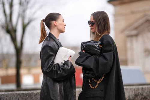 Sofia Roe wears a white Balenciaga bag, a black leather blazer jacket, Charlotte Groeneveld wears a black oversized blazer jacket as a dress, a black...