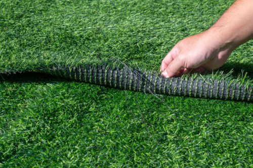 someone hand pulling an artificial turf before replacement. artificial turf is used for covering sport arena or garden. - garden decoration stock pictures, royalty-free photos & images