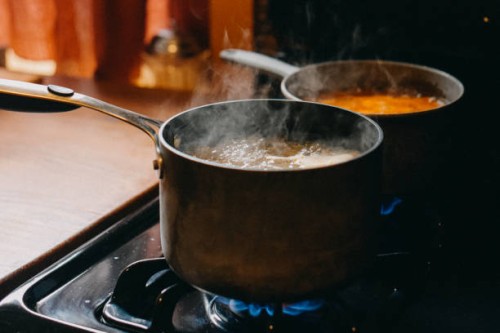 soup boiling in cooking pans on gas burning stove - food stock pictures, royalty-free photos & images