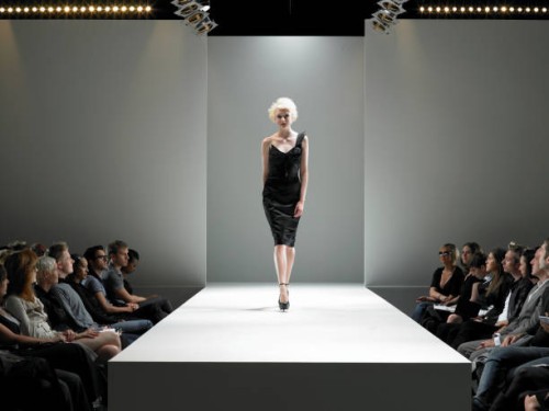 spectators watching fashion model on catwalk - fashion stock pictures, royalty-free photos & images