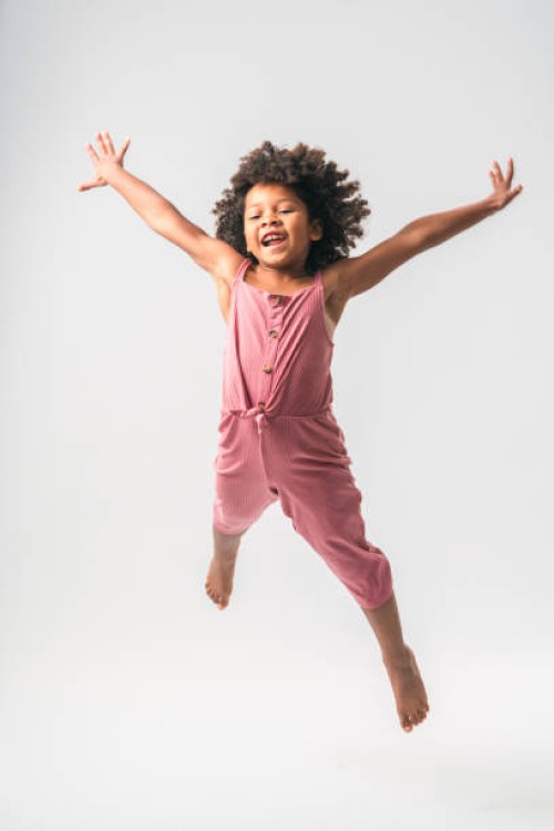 sporty black little girl jumping high - fashion stock pictures, royalty-free photos & images