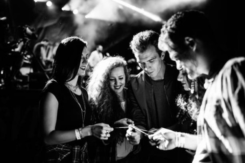 spraklers glowing, smile on their faces, favorite band playing, let's get this party started. black and white photo - concert stock pictures, royalty-free photos & images