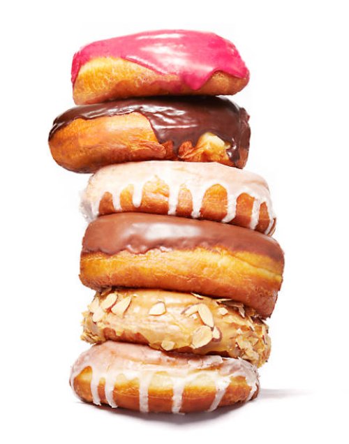 stack of doughnuts - junk food stock pictures, royalty-free photos & images