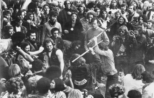 Still from the documentary film 'Gimme Shelter', showing audience members looking on as Hells Angels beat a fan with pool cues at the Altamont Free...