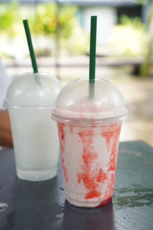 strawberry yogurt smoothie coconut smoothie​ in plastic​ cub - junk food stock pictures, royalty-free photos & images