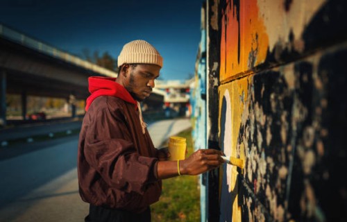 street artist drawing graffiti on the wall. - fashion stock pictures, royalty-free photos & images