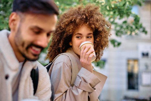 students drinking coffee and smiling during a break between classes - junk food stock pictures, royalty-free photos & images