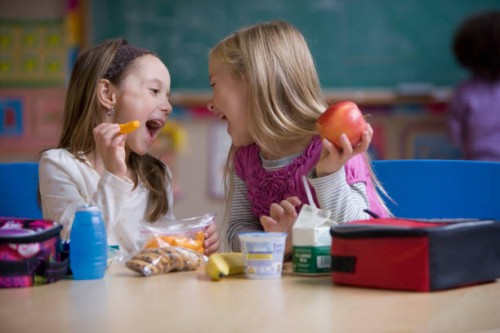 students eating lunch in classroom - junk food stock pictures, royalty-free photos & images