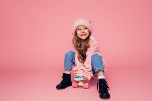 studio portrait of a cute girl with skateboard - fashion stock pictures, royalty-free photos & images