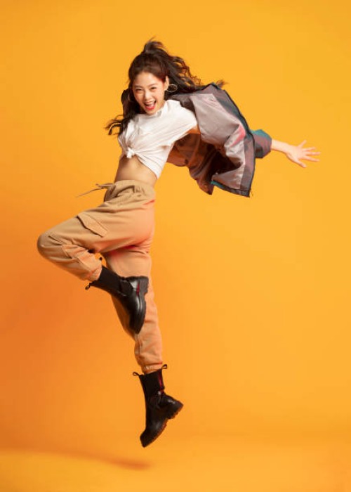 studio shot of fashionable young woman dancing - fashion stock pictures, royalty-free photos & images