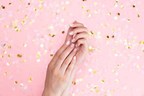 stylish female pink and white manicure. beautiful young woman's hands on pink pastel background with festive multicolored confetti. trendy geometric pattern. art manicure. - nails art stock pictures, royalty-free photos & ima