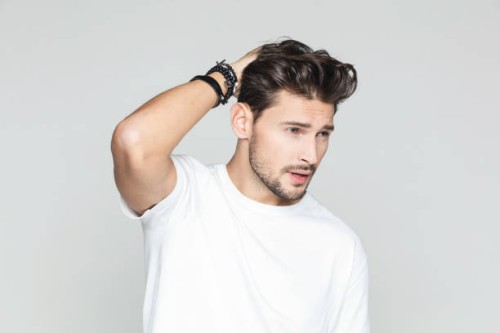 stylish man posing on grey background - fashion stock pictures, royalty-free photos & images