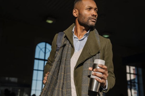 stylish man with reusable cup getting out of the train station - junk food stock pictures, royalty-free photos & images
