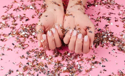 stylish pastel pink beige nails holding many multicolored sparkles - nails art stock pictures, royalty-free photos & images