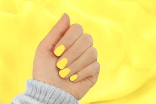 stylish trendy yellow manicure on illuminating yellow colour silk scarf background. - nails art stock pictures, royalty-free photos & images