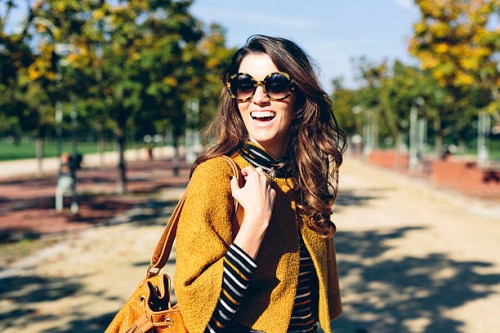 stylish woman at the park on a sunny autumn day - fashion stock pictures, royalty-free photos & images