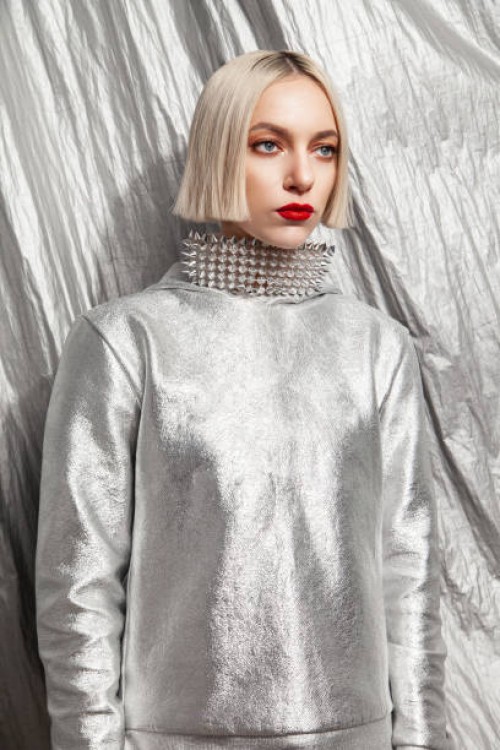 stylish woman in extravagant metallic wear with silver background - fashion stock pictures, royalty-free photos & images