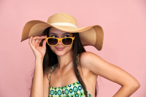 stylish woman posing with sun hat and sunglasses - fashion stock pictures, royalty-free photos & images