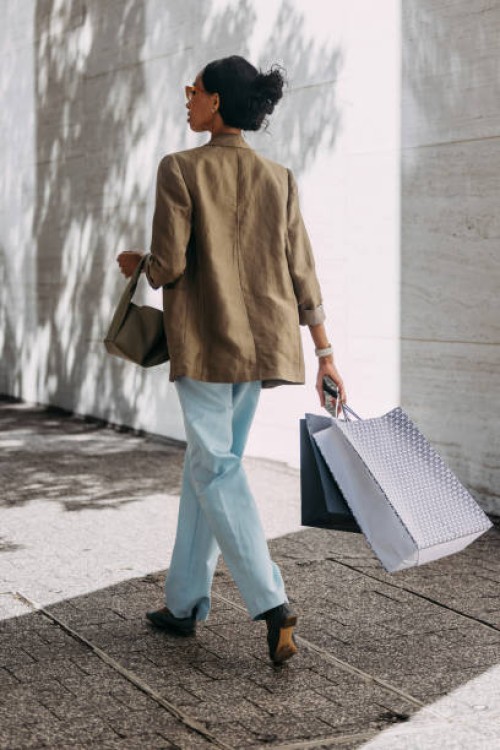 stylish woman walking outdoors with shopping bags - fashion stock pictures, royalty-free photos & images