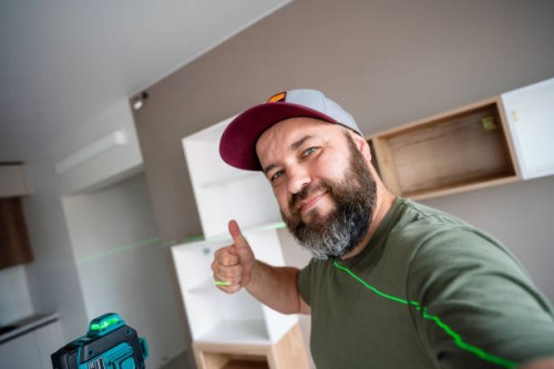 successful installing and leveling shelves in the apartment using the professional laser level - home decoration stock pictures, royalty-free photos & images