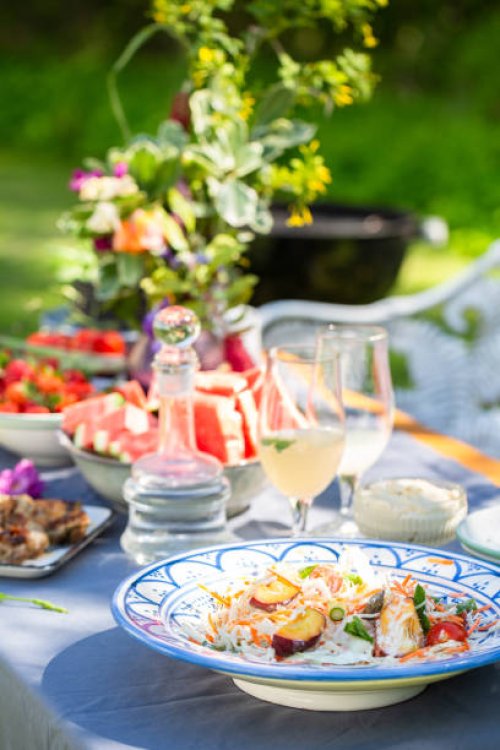 summer outdoor table setting with salad, food and flowers - garden decoration stock pictures, royalty-free photos & images