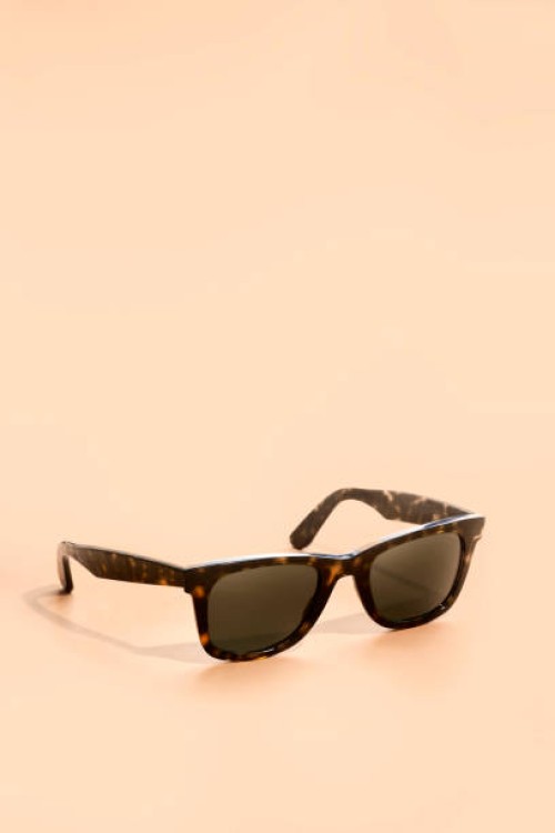sunglasses on brown background - fashion stock pictures, royalty-free photos & images