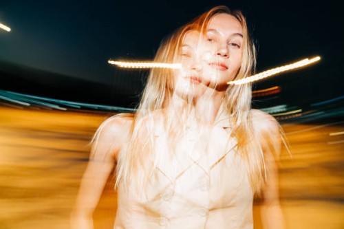 surreal double exposure portrait of a blonde woman with motion blur at night - fashion stock pictures, royalty-free photos & images