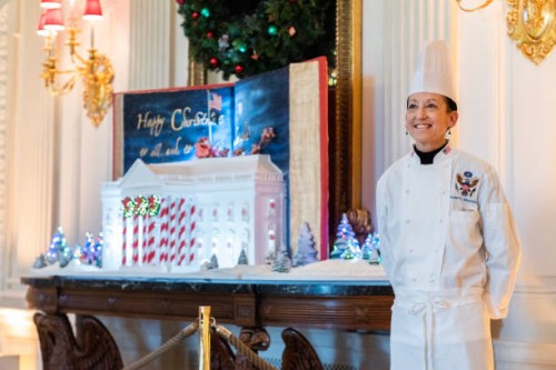 Susan Morrison, White House Executive Pastry Chef, stands with The Gingerbread White House in the State Dining Room during the media preview of the...