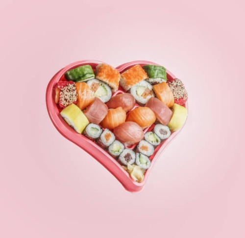 sushi set in heart shaped box at pink background. flying food levitation. - junk food stock pictures, royalty-free photos & images