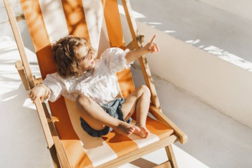 sweet cute baby enjoying on sun bed or chaise lounge. summer children fashion style - fashion stock pictures, royalty-free photos & images