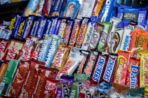 Sweets, confectionary and various well known branded chocolate bars for sale at a small shop on 4th December 2024 in London, United Kingdom.