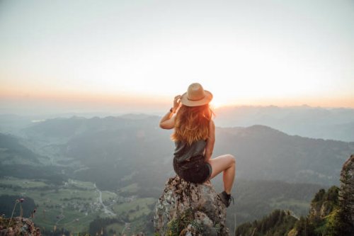 switzerland, grosser mythen, young woman on a hiking trip sitting on a rock at sunrise - travel stock pictures, royalty-free photos & images