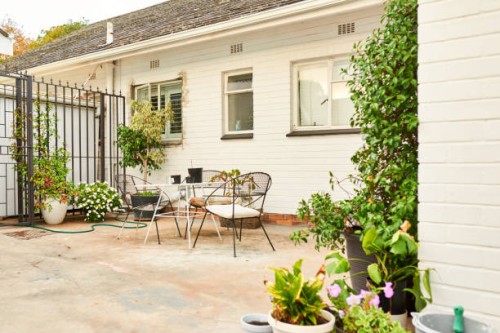 table and chairs sitting outside on the patio of a home - garden decoration stock pictures, royalty-free photos & images
